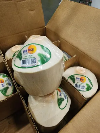 Box full of Cocotico's fresh diamond shaped coconuts
