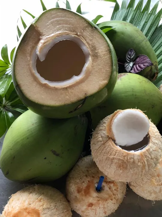 Box full of Cocotico's fresh green coconuts